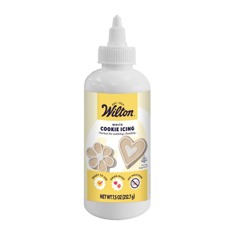 Bottle of Wilton white cookie icing on a white background