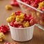White Wilton nut cups filled with coloured popcorn