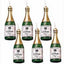 A set of six champagne bottle-shaped candles with green labels and gold accents.
