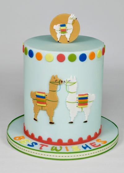 A blue cake with colourful llama cut outs