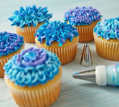 Examples of piped blue buttercream cupcakes using Wilton tip 54