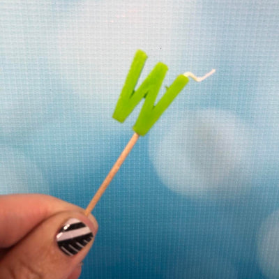 Alphabet or numeral candle on wooden pick Letter W Green
