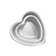 A set of three white, heart-shaped cake pans stacked together.