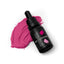 A bottle of SPRINKS brand food coloring in magenta pink, with a dropper, placed next to a swatch of the pink color.