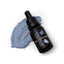 A bottle of SPRINKS Denim Blue Gel Colour with a dropper, placed next to a swatch of the blue color.