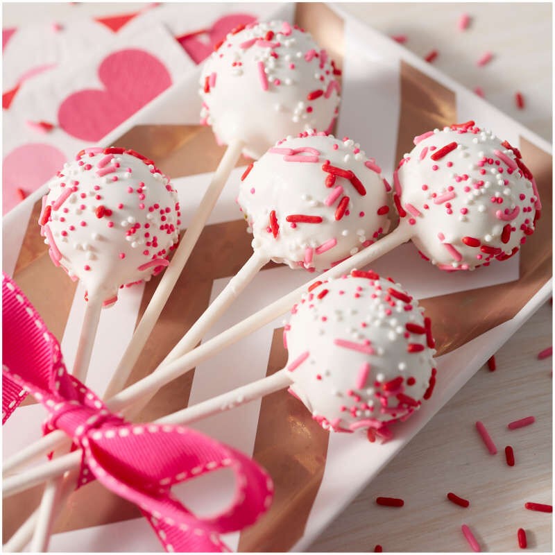 Example of Cake pops dipped in bright white candy melts decorated with sprinkles