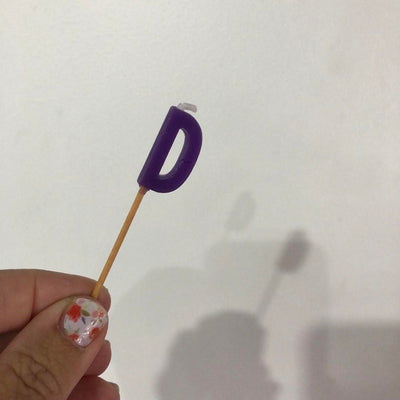 Alphabet or numeral candle on wooden pick Letter D Purple