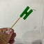 Alphabet or numeral candle on wooden pick Letter H Green