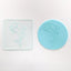 A clear acrylic debosser with a dolphin design, alongside a teal fondant example.