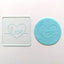 Love clear acrylic debosser with teal fondant example of use