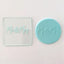 Mr & Mrs teal fondant plaque, alongside the debossing tool used to make it