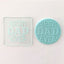 Debosser embossers with the text 'BEST DAD EVER' imprinted on it, With teal example of icing embossed from it