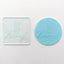 An embossing tool with the phrase 'HIP HIP HOORAY!' imprinted on it. Alongside a teal fondant icing plaque made using it